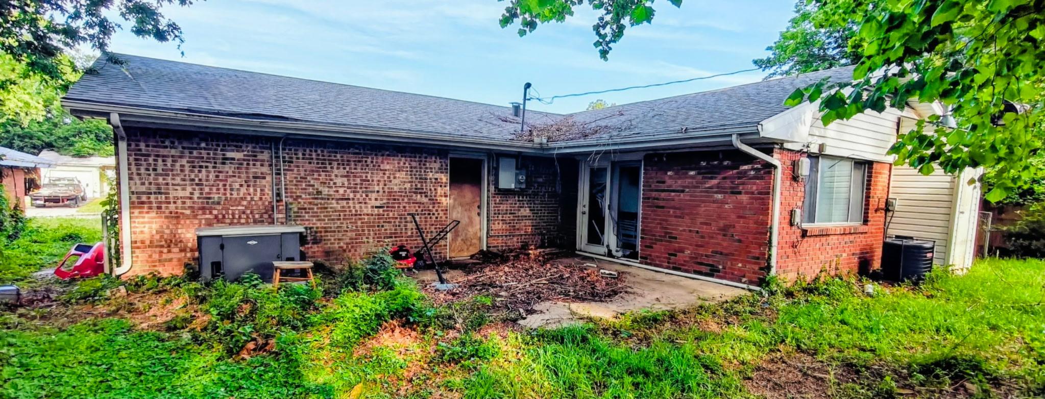 Back exterior with patio and yard