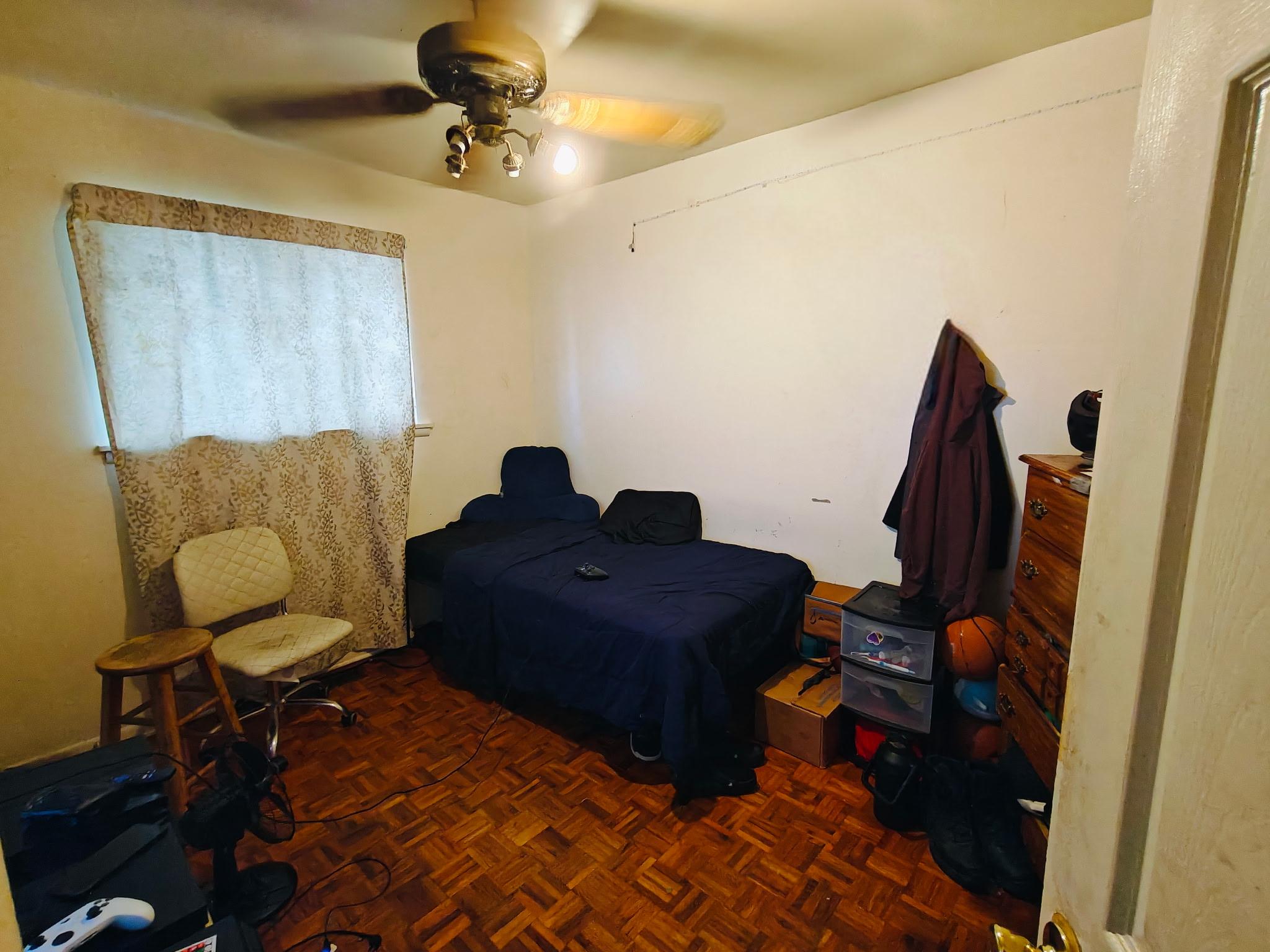 Bedroom with parquet floors. (flooring has not been replaced).