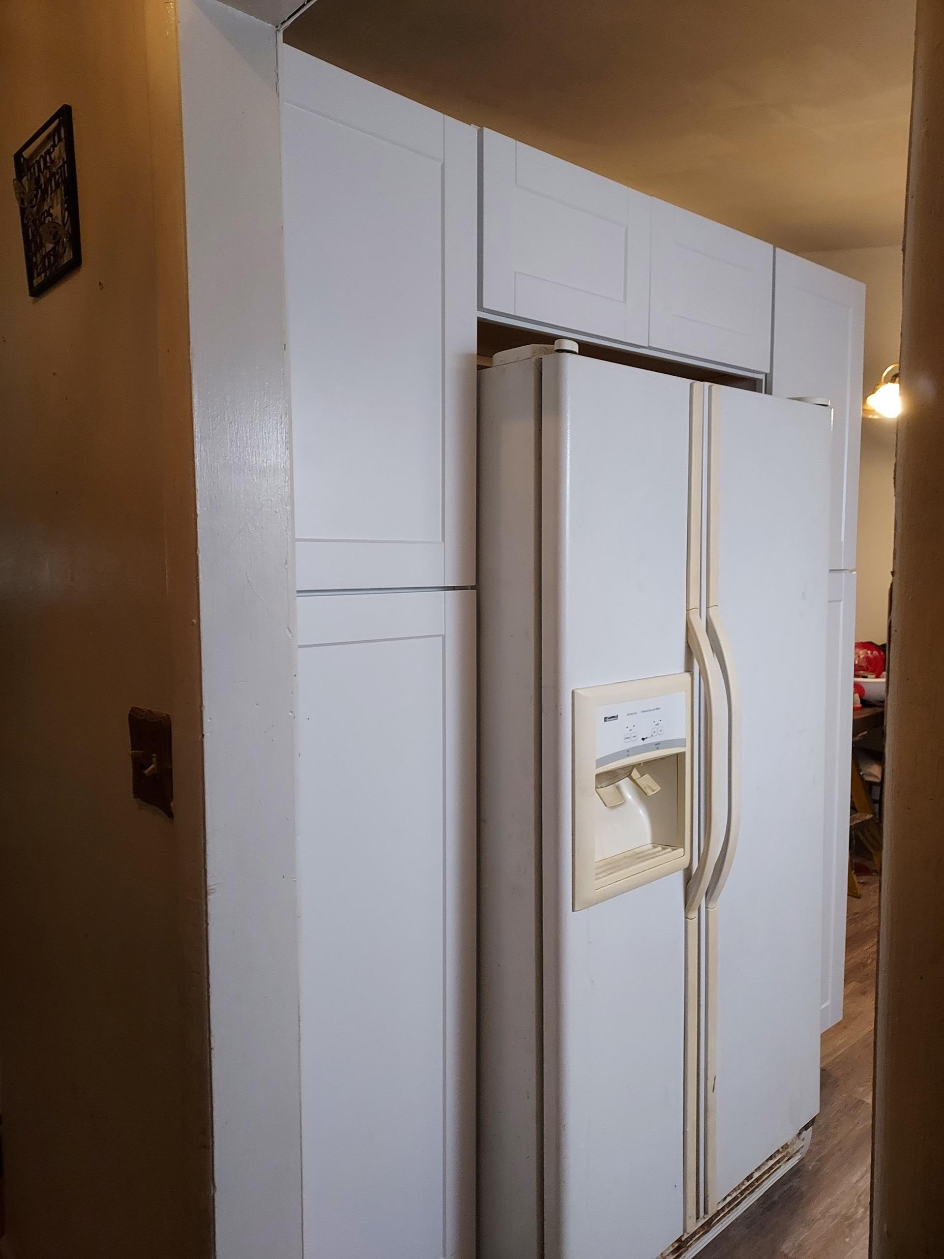 Kitchen with refrigerator and cabinets