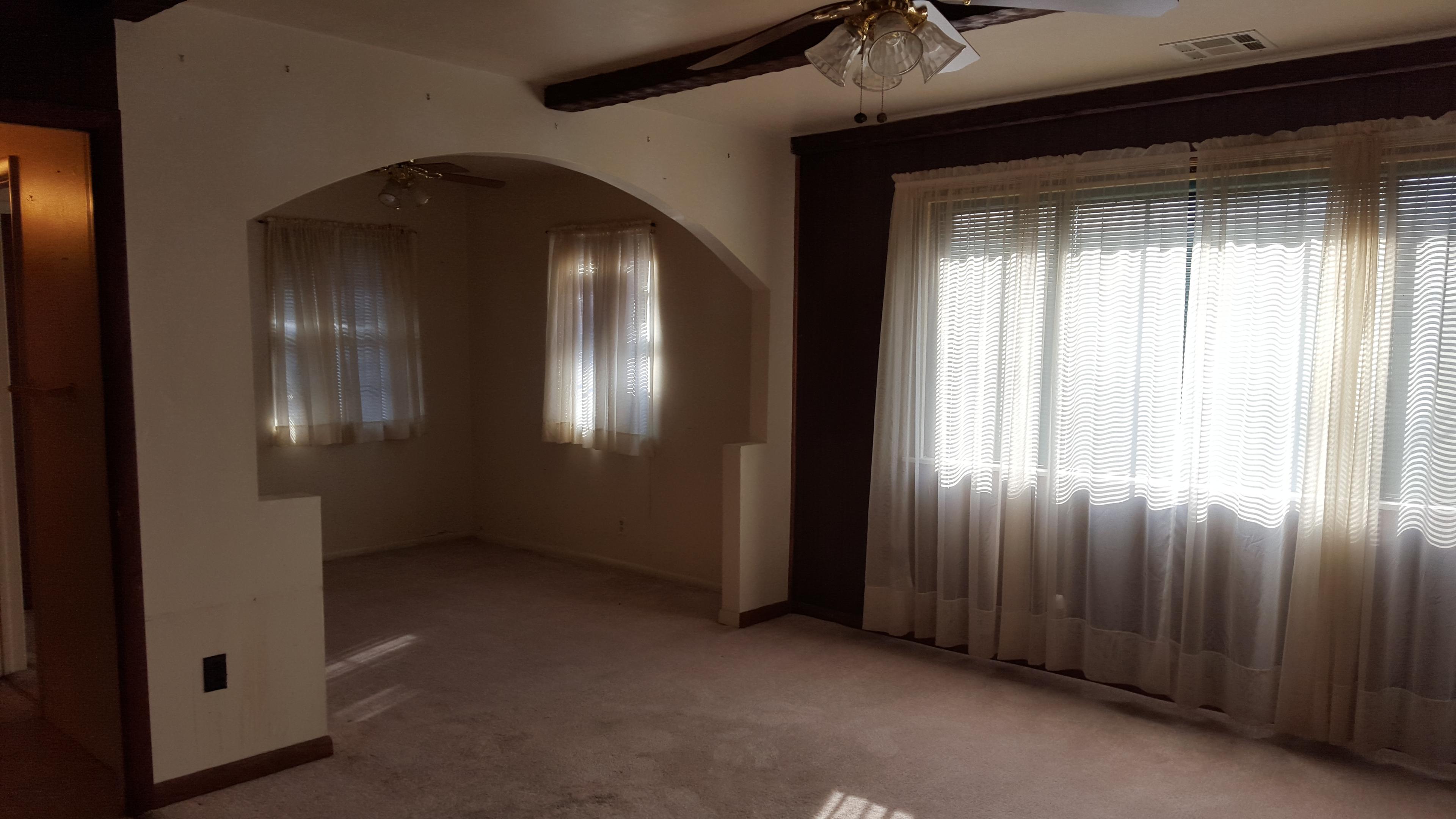 Living room with arched doorway and ceiling fan