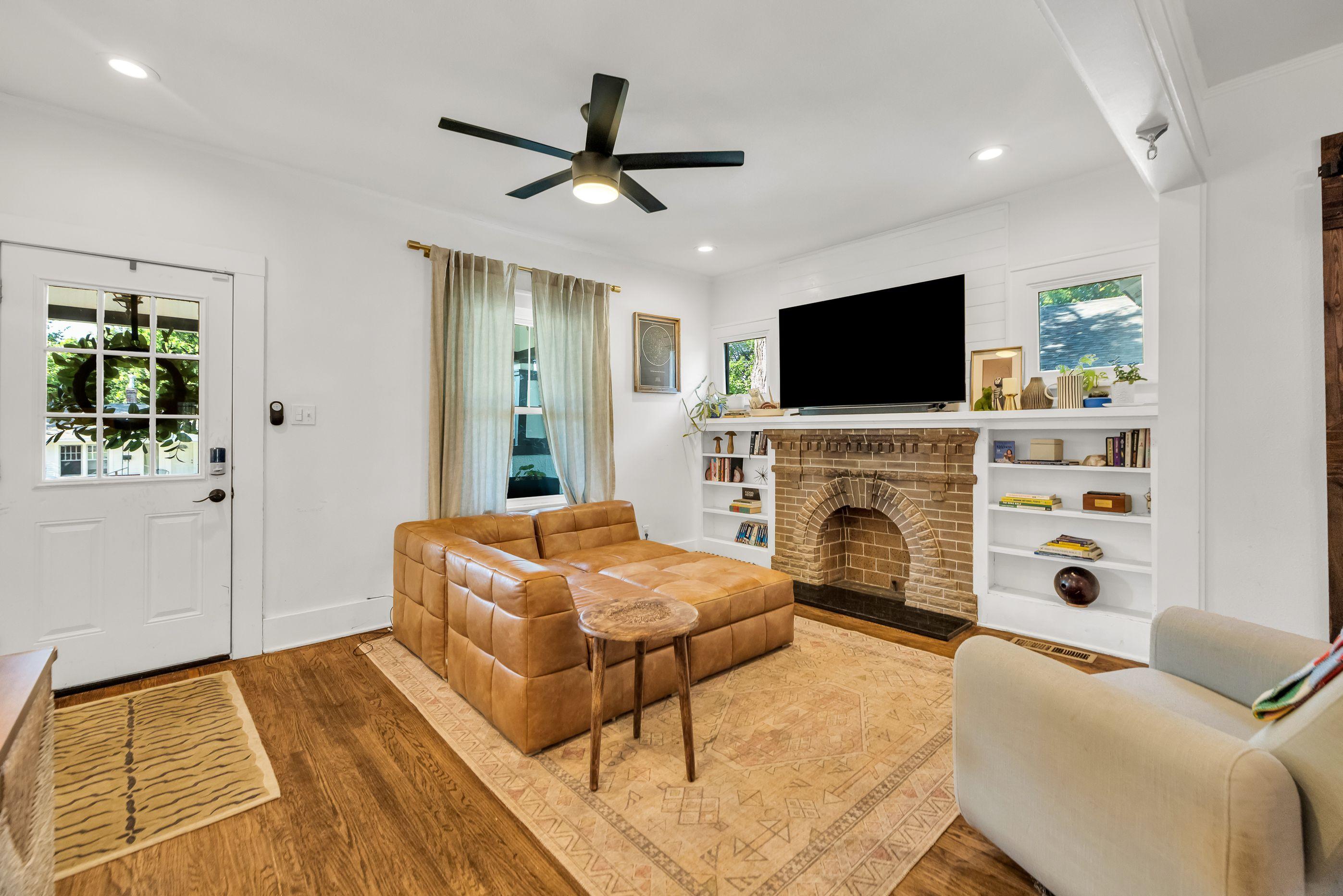 Living room with brick fireplace and built-ins